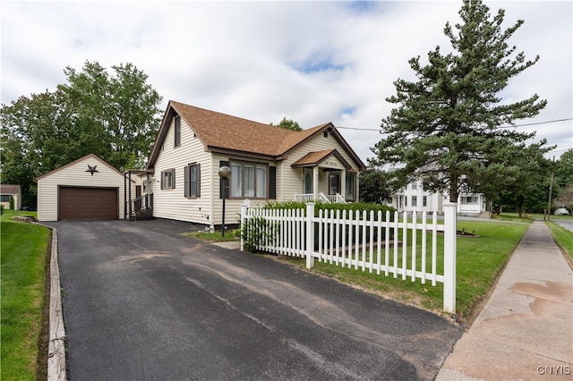 view of front of property featuring a garage, an outbuilding, and a front yard