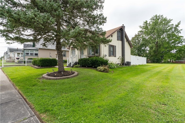 exterior space with central air condition unit and a front yard