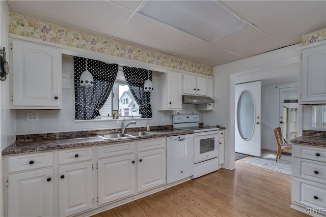 kitchen with light wood-type flooring, white cabinets, white appliances, and sink