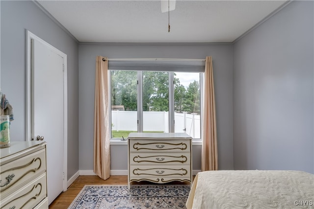 bedroom with ornamental molding and wood-type flooring