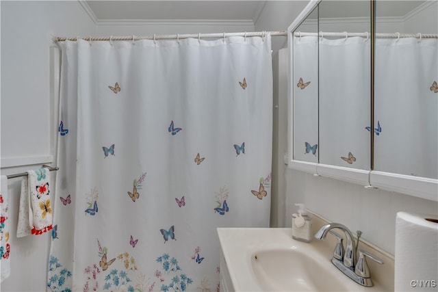 bathroom with ornamental molding, vanity, and curtained shower