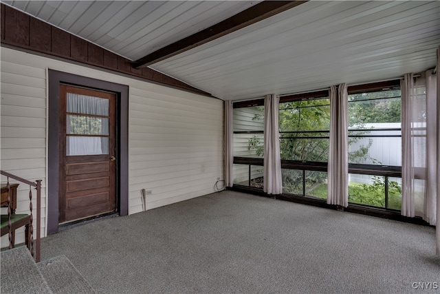 unfurnished sunroom with vaulted ceiling with beams