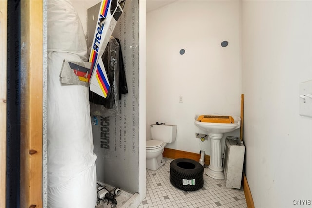 bathroom with toilet and tile patterned floors