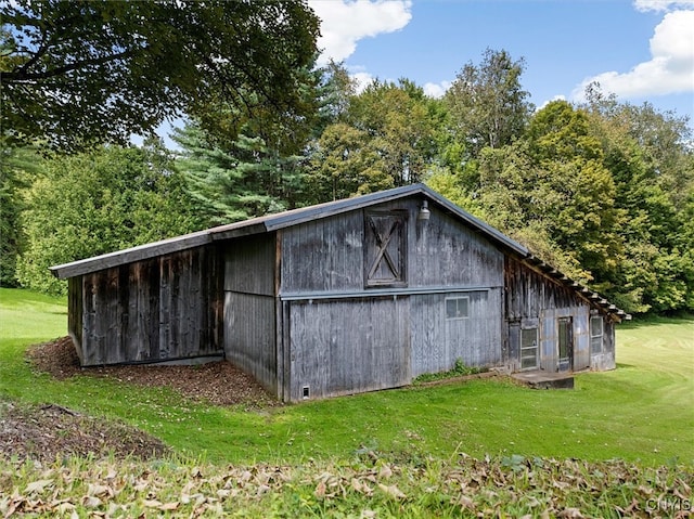 view of outbuilding with a yard