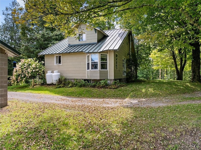 view of property exterior with a lawn