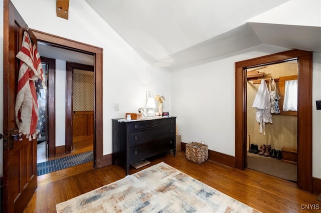 bedroom featuring lofted ceiling and dark hardwood / wood-style floors