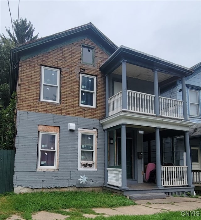 view of front of home with covered porch and a balcony