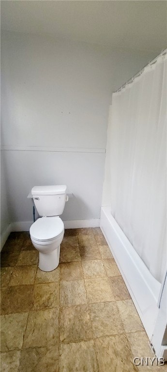 bathroom with toilet and shower / bath combo