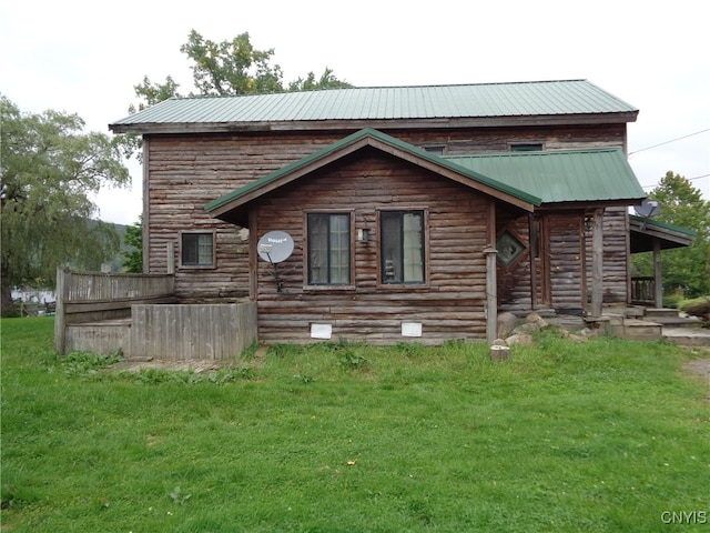 rear view of property featuring a yard