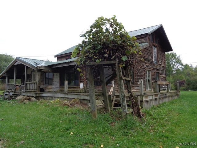 back of property with a lawn and a wooden deck