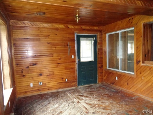 entryway featuring wood ceiling, hardwood / wood-style floors, and wooden walls