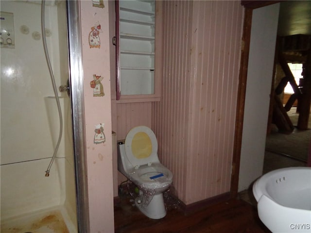 bathroom featuring wood-type flooring and toilet