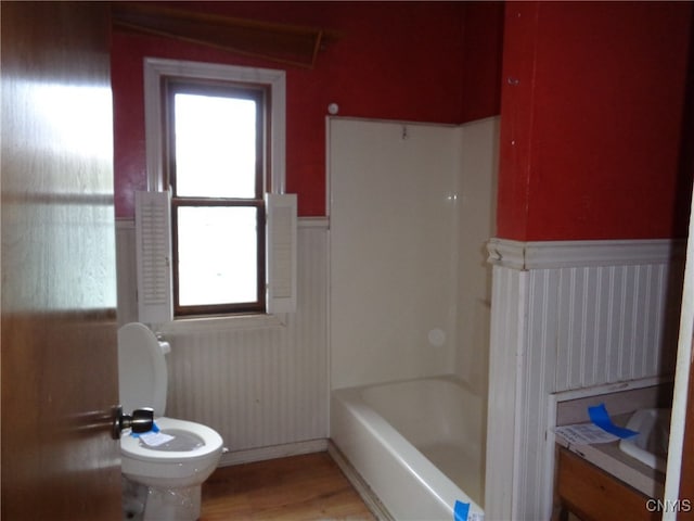 full bathroom featuring vanity, toilet, hardwood / wood-style flooring, and shower / tub combination