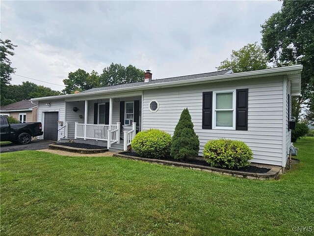 view of front facade with a garage, a front yard, and a porch