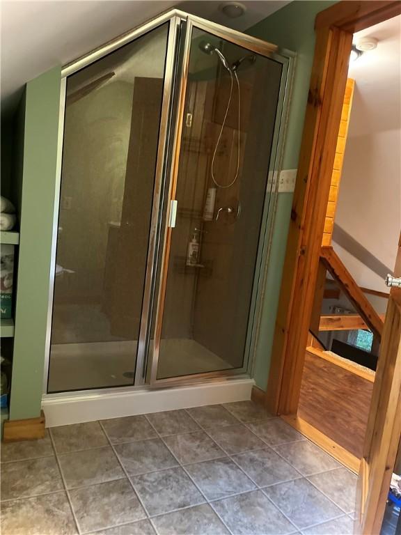 bathroom with tile patterned flooring and an enclosed shower