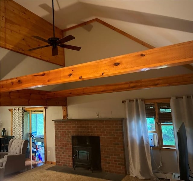 unfurnished living room with vaulted ceiling with beams, plenty of natural light, a wood stove, and carpet floors