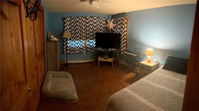 bedroom with ceiling fan and a baseboard heating unit