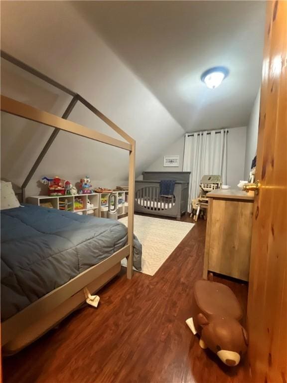 bedroom with hardwood / wood-style flooring and vaulted ceiling