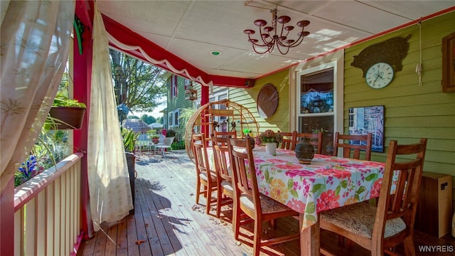 dining room with an inviting chandelier, wood-type flooring, and wooden walls