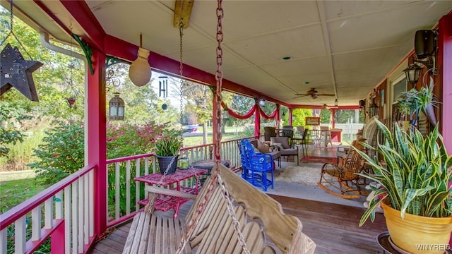 deck with ceiling fan and a porch