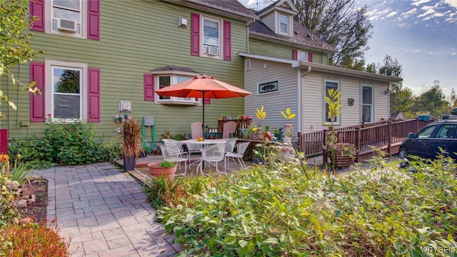 rear view of house featuring cooling unit and a patio area