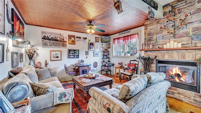 living room with ceiling fan, parquet floors, wood ceiling, and a fireplace