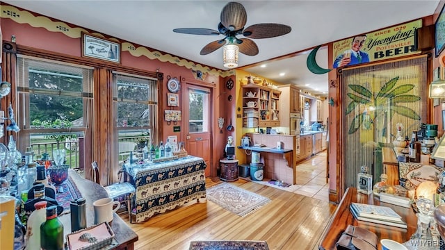 office area with light wood-type flooring and ceiling fan