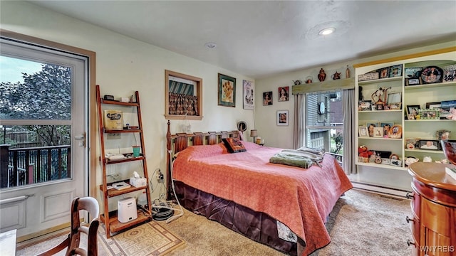 carpeted bedroom with a baseboard radiator