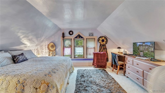 bedroom featuring light carpet and lofted ceiling