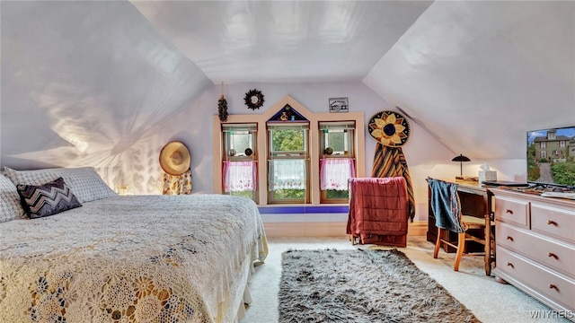 bedroom with light carpet and lofted ceiling