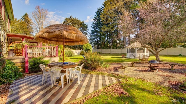 view of patio featuring an outdoor fire pit, a gazebo, and a wooden deck