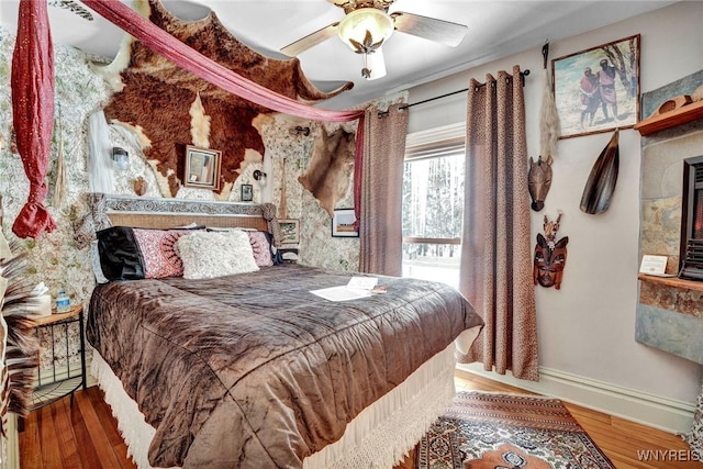 bedroom with ceiling fan and wood-type flooring