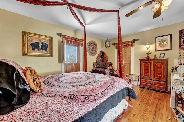 bedroom with ceiling fan and light wood-type flooring