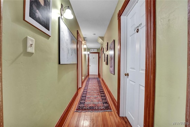 corridor with light hardwood / wood-style flooring