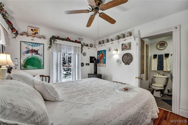 bedroom with ceiling fan, ensuite bathroom, and hardwood / wood-style floors