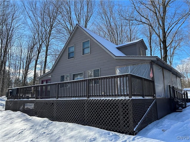 snow covered property with a deck