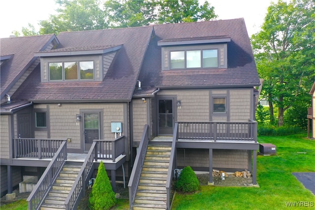 view of front facade featuring a front yard and a wooden deck