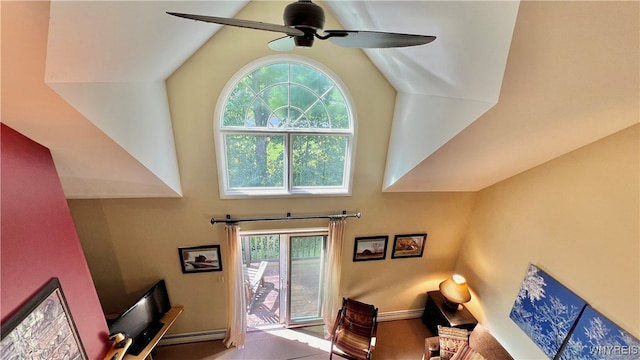 living room with baseboard heating, ceiling fan, and lofted ceiling