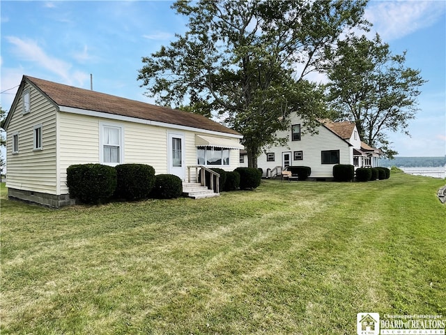 exterior space with a yard and a water view