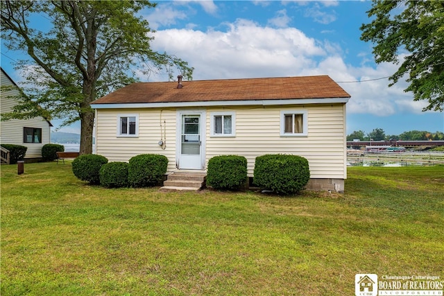 rear view of house with a yard