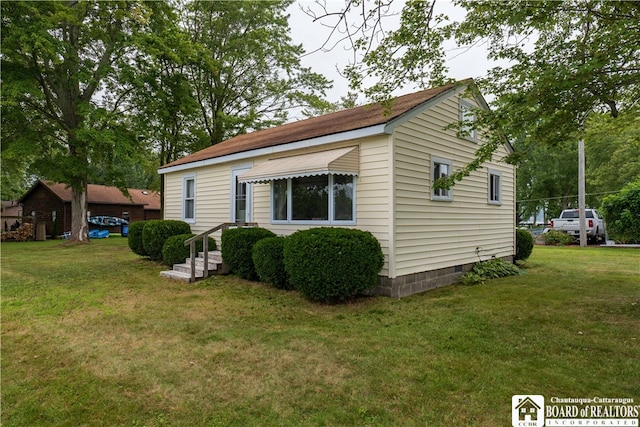 view of property exterior featuring a lawn