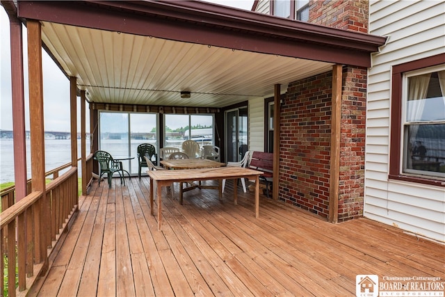 wooden deck featuring a water view