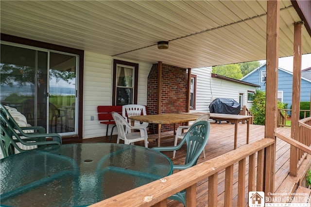 wooden deck featuring a grill