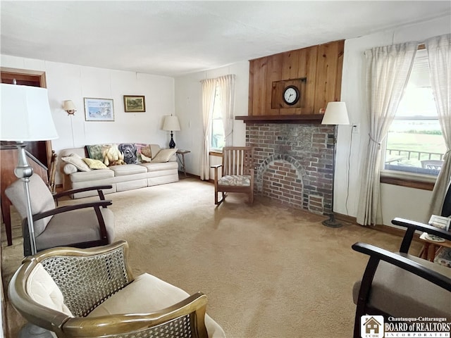 living room featuring a fireplace, carpet floors, and plenty of natural light