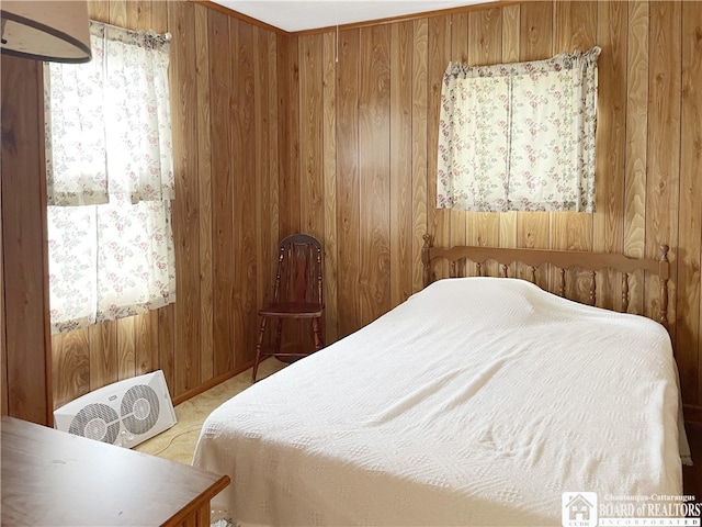 carpeted bedroom featuring wood walls