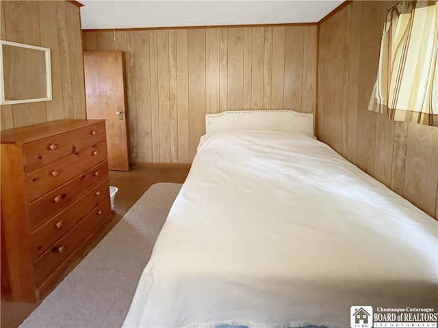 bedroom featuring wooden walls