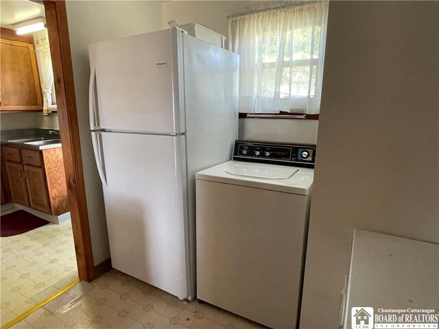 washroom with washer / clothes dryer and sink