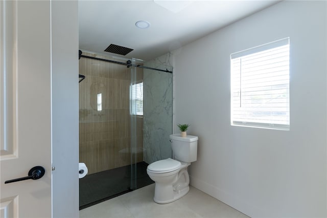 bathroom with toilet, a shower with shower door, and tile patterned floors