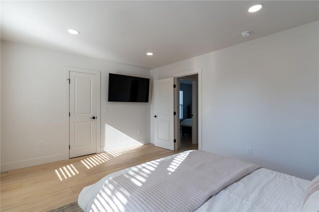 bedroom with light hardwood / wood-style floors