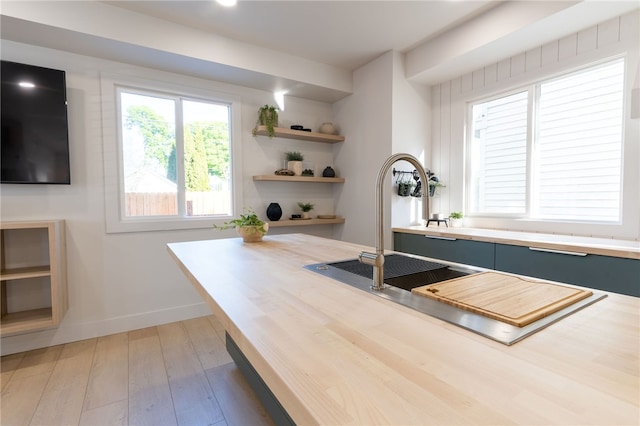 unfurnished office featuring hardwood / wood-style flooring and sink